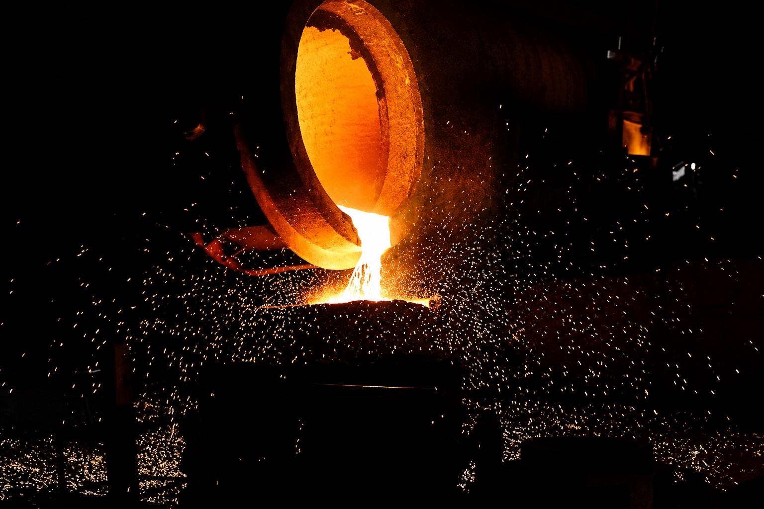 Molten metal being poured in an investment casting foundry